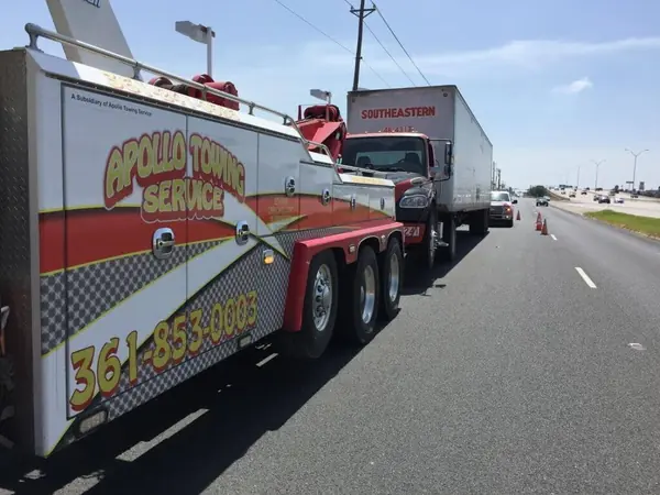 Apollo Towing heavy wrecker towing a semi-truck